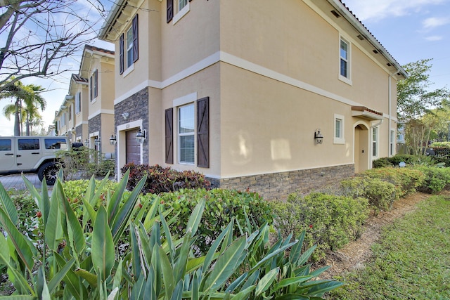 view of side of home featuring a garage