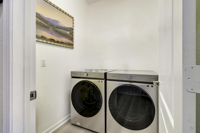 clothes washing area featuring separate washer and dryer