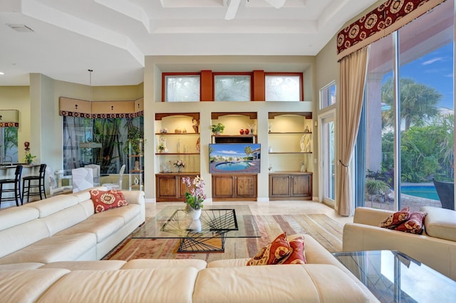 living room featuring built in shelves and a towering ceiling