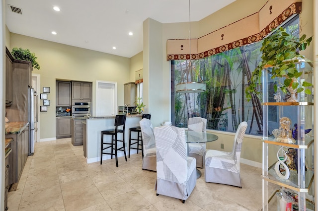 dining room with a high ceiling