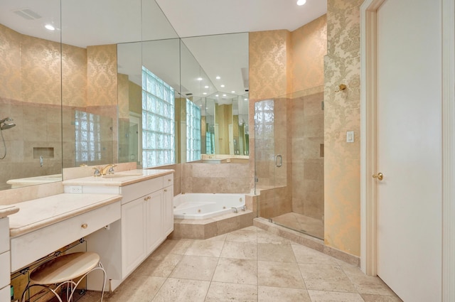 bathroom featuring tile patterned floors, vanity, shower with separate bathtub, and tile walls