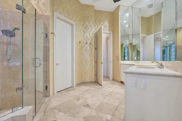 bathroom with vanity and a shower with door