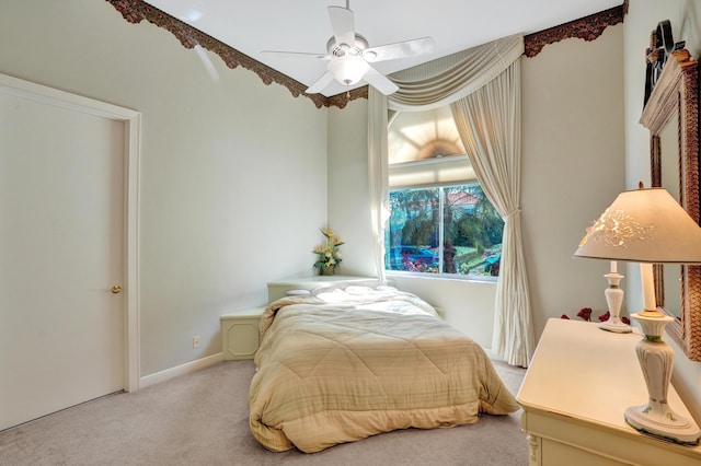 bedroom featuring ceiling fan and light carpet