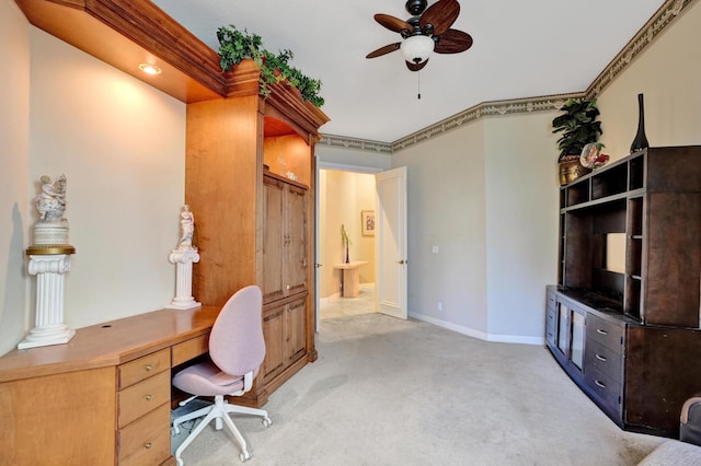 carpeted office featuring crown molding and ceiling fan