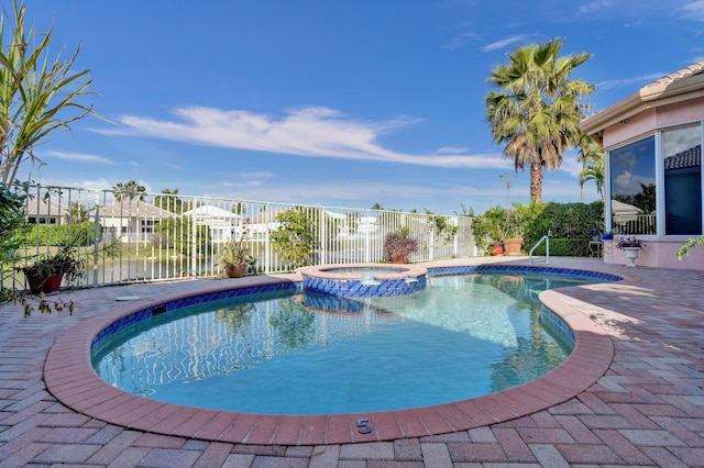 view of pool with an in ground hot tub and a patio