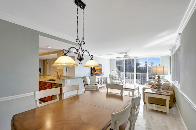 dining area with expansive windows, crown molding, sink, and ceiling fan