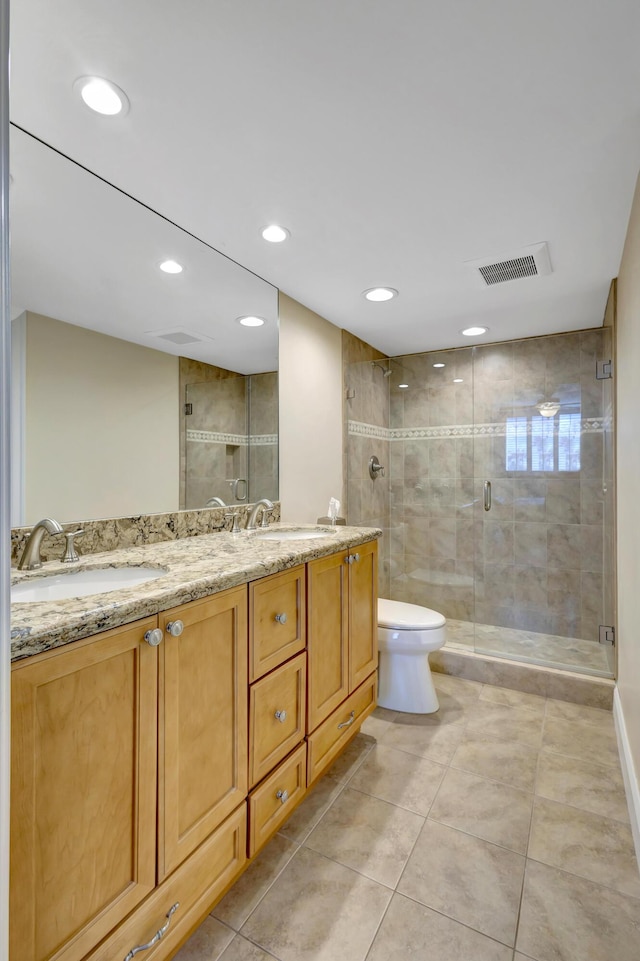 bathroom featuring walk in shower, tile patterned floors, vanity, and toilet