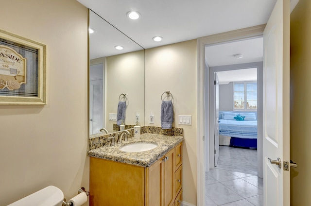 bathroom featuring tile patterned floors, vanity, and toilet