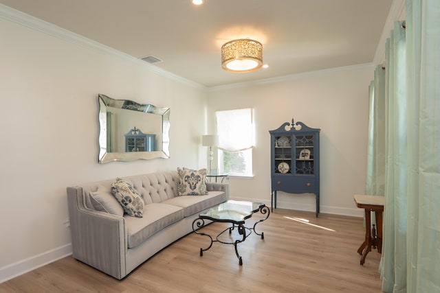 living room with ornamental molding and light hardwood / wood-style floors