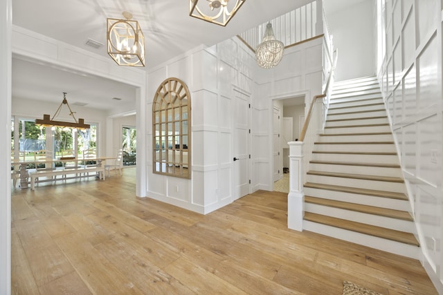 entrance foyer featuring hardwood / wood-style flooring and an inviting chandelier