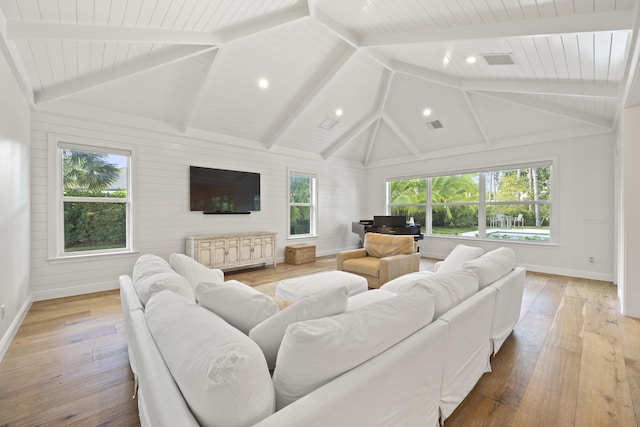 living room with vaulted ceiling with beams, wood ceiling, and light hardwood / wood-style flooring