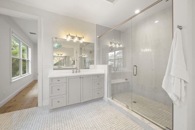 bathroom featuring an enclosed shower and vanity