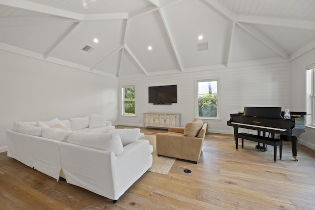 living room with beam ceiling, light hardwood / wood-style flooring, and high vaulted ceiling