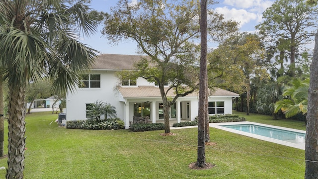 rear view of house with a lawn