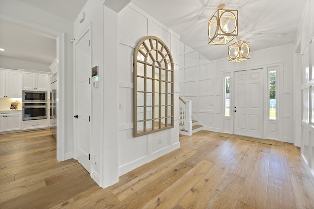 foyer featuring an inviting chandelier and light hardwood / wood-style floors