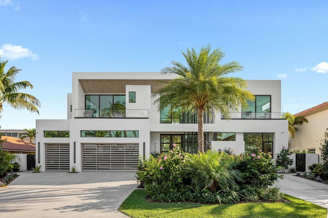 contemporary house with stucco siding and concrete driveway