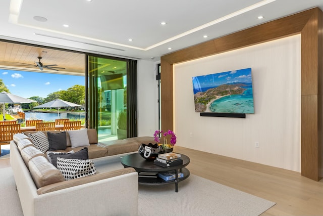 living area with recessed lighting, expansive windows, a ceiling fan, and wood finished floors