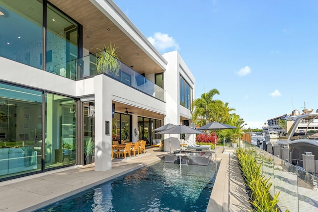 pool with outdoor dining space and a patio