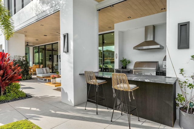 view of patio featuring outdoor wet bar, area for grilling, and an outdoor kitchen