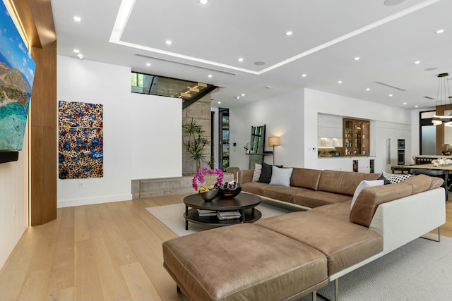 living area with recessed lighting and light wood-style floors