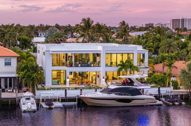 rear view of house featuring a water view