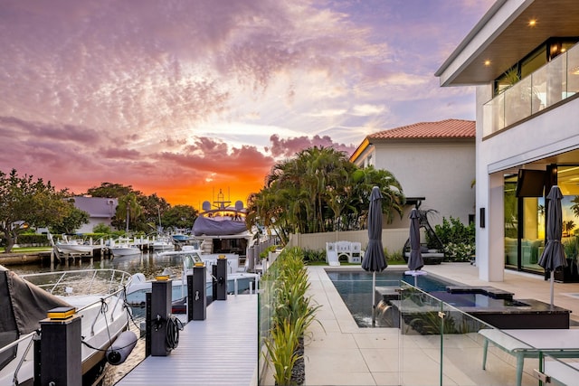 exterior space featuring a patio, fence, and a water view