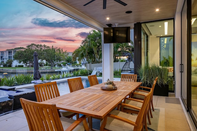 view of patio featuring ceiling fan, outdoor dining space, and fence