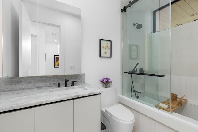 bathroom with enclosed tub / shower combo, toilet, and vanity