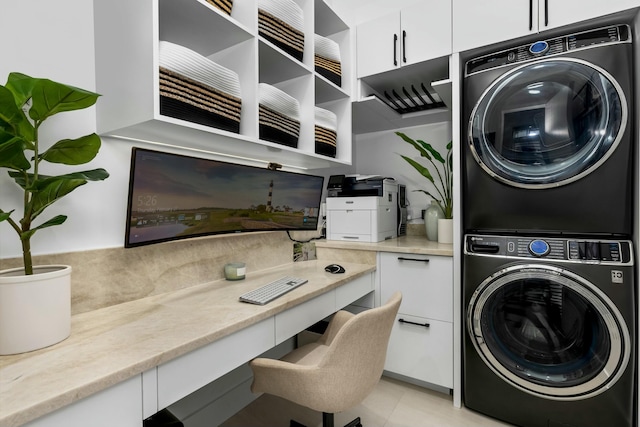 laundry area featuring cabinet space and stacked washing maching and dryer