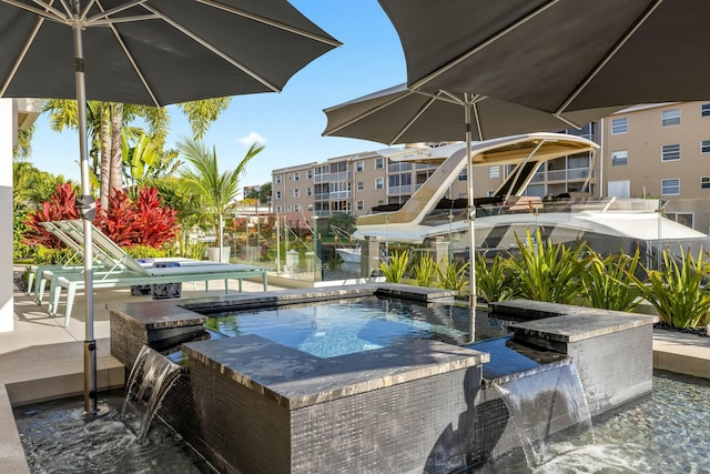 view of swimming pool featuring a jacuzzi