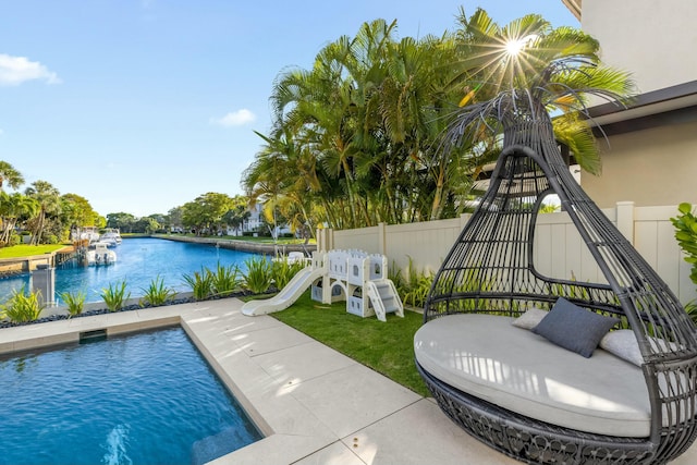 pool with fence and a water view