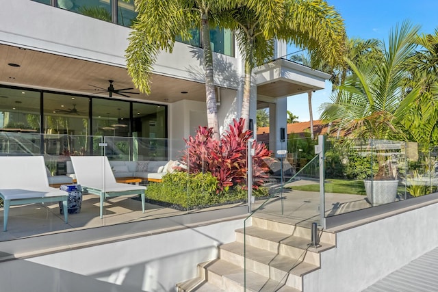 view of patio / terrace featuring a balcony, ceiling fan, and fence