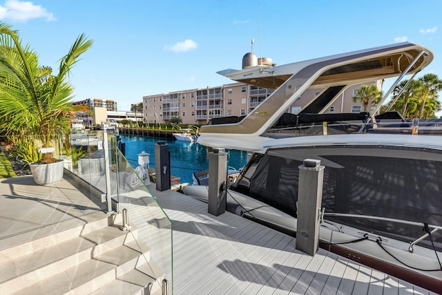 view of swimming pool featuring a boat dock and a water view