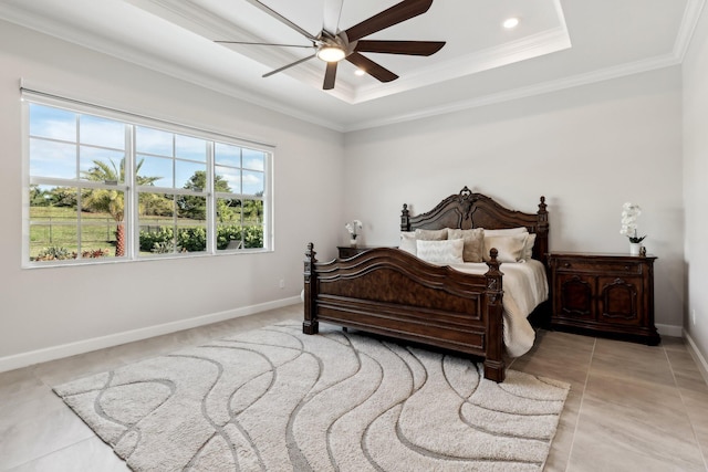 tiled bedroom featuring a tray ceiling, ornamental molding, and ceiling fan