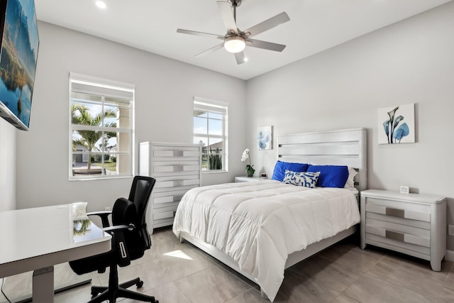 tiled bedroom featuring ceiling fan