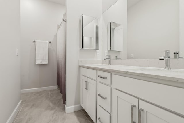 bathroom with tile patterned floors and vanity