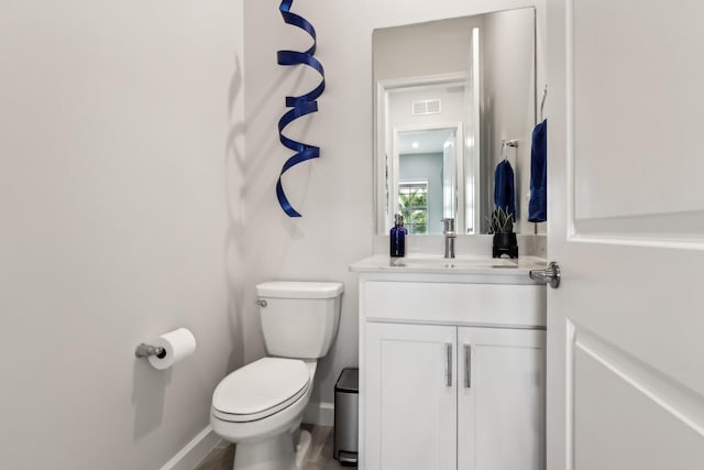 bathroom featuring vanity and toilet