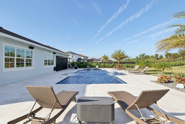 view of swimming pool with pool water feature and a patio area