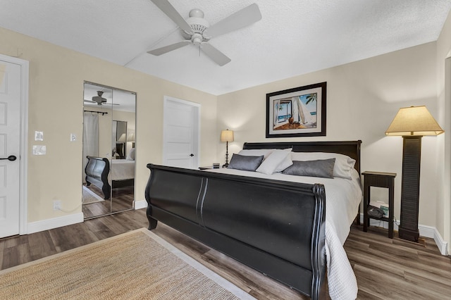 bedroom with wood-type flooring, ceiling fan, a textured ceiling, and a closet