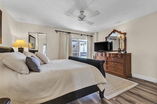 bedroom with ceiling fan, access to exterior, dark hardwood / wood-style flooring, and a textured ceiling