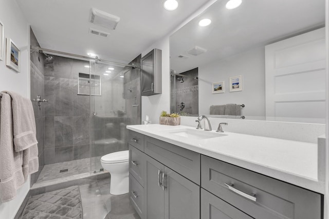 bathroom with vanity, toilet, and an enclosed shower