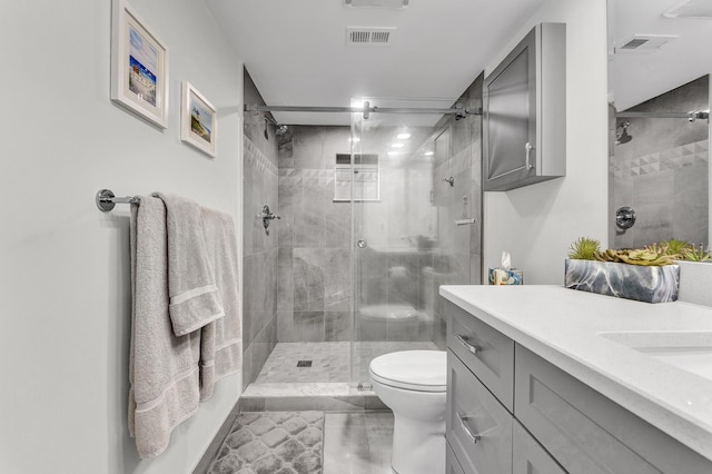 bathroom with vanity, toilet, and an enclosed shower