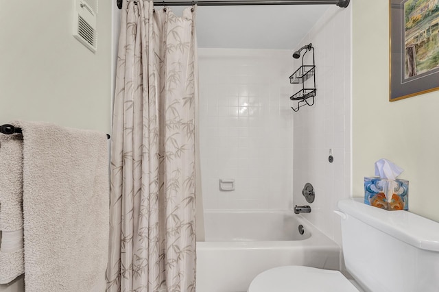 bathroom with shower / tub combo with curtain and toilet