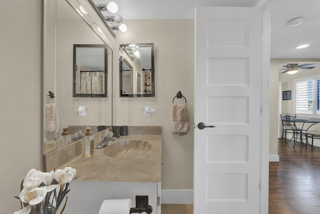 bathroom featuring ceiling fan, vanity, and hardwood / wood-style floors