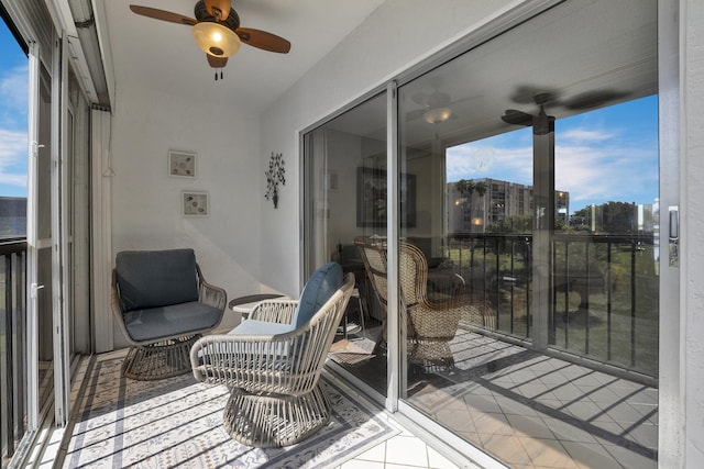 sunroom featuring ceiling fan