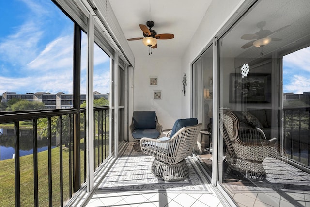 sunroom / solarium featuring ceiling fan