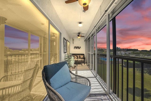 sunroom / solarium featuring ceiling fan