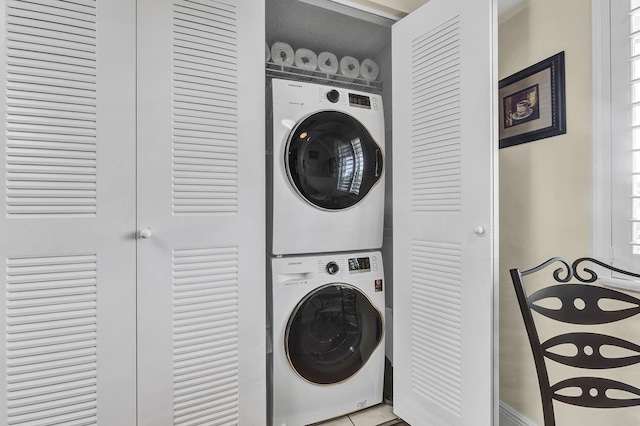 clothes washing area with stacked washer and clothes dryer