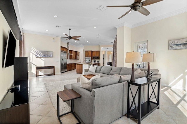 living room with light tile patterned floors, crown molding, a wealth of natural light, and ceiling fan