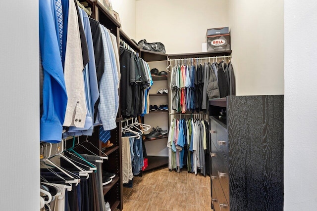 walk in closet with wood-type flooring